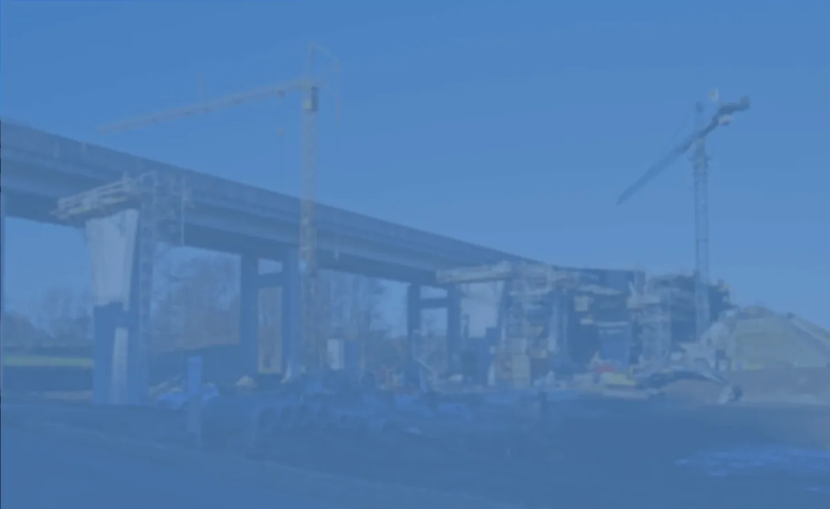 Construction site with steel framework and crane under clear blue sky