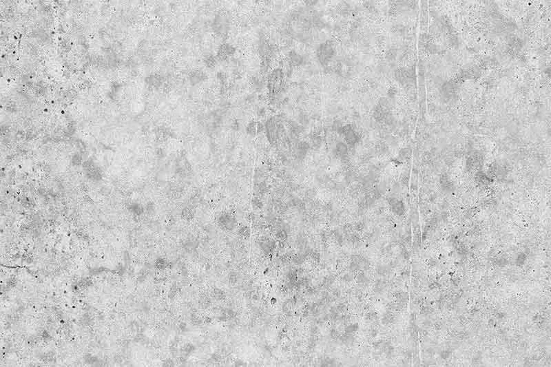 Rough gray concrete surface with stone aggregate
