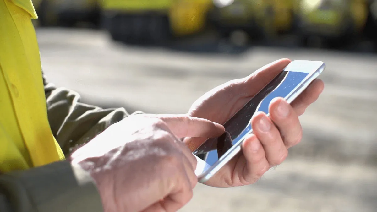 Construction worker using Novade mobile app for site inspections and testing