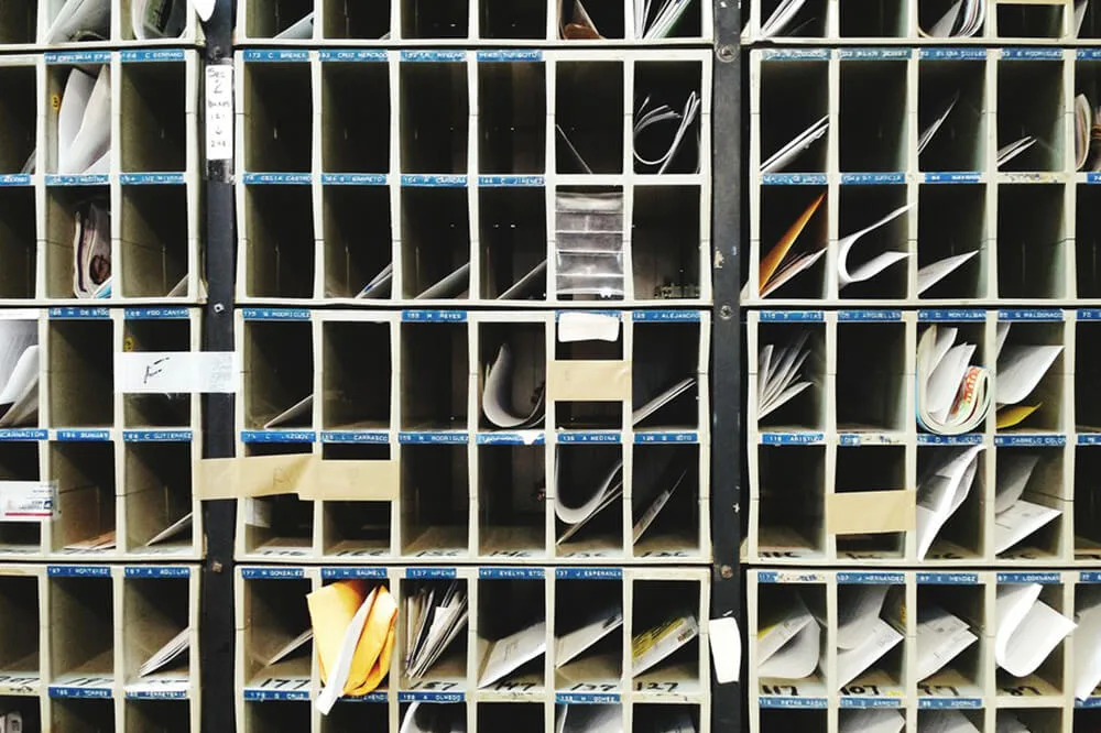 Construction site pigeonhole storage system organizing blueprints, cables, and materials