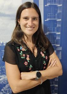 Novade team member posed against architectural blueprint background