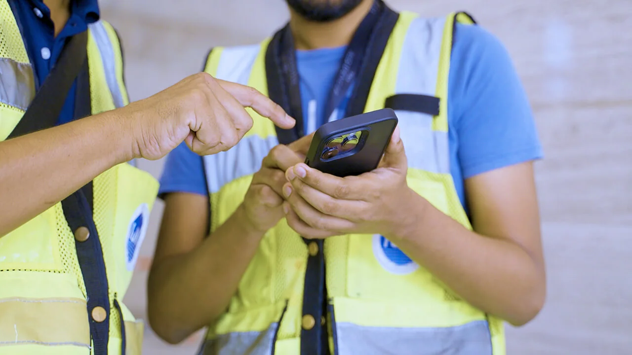 Workers using mobile app for site inspection and quality control