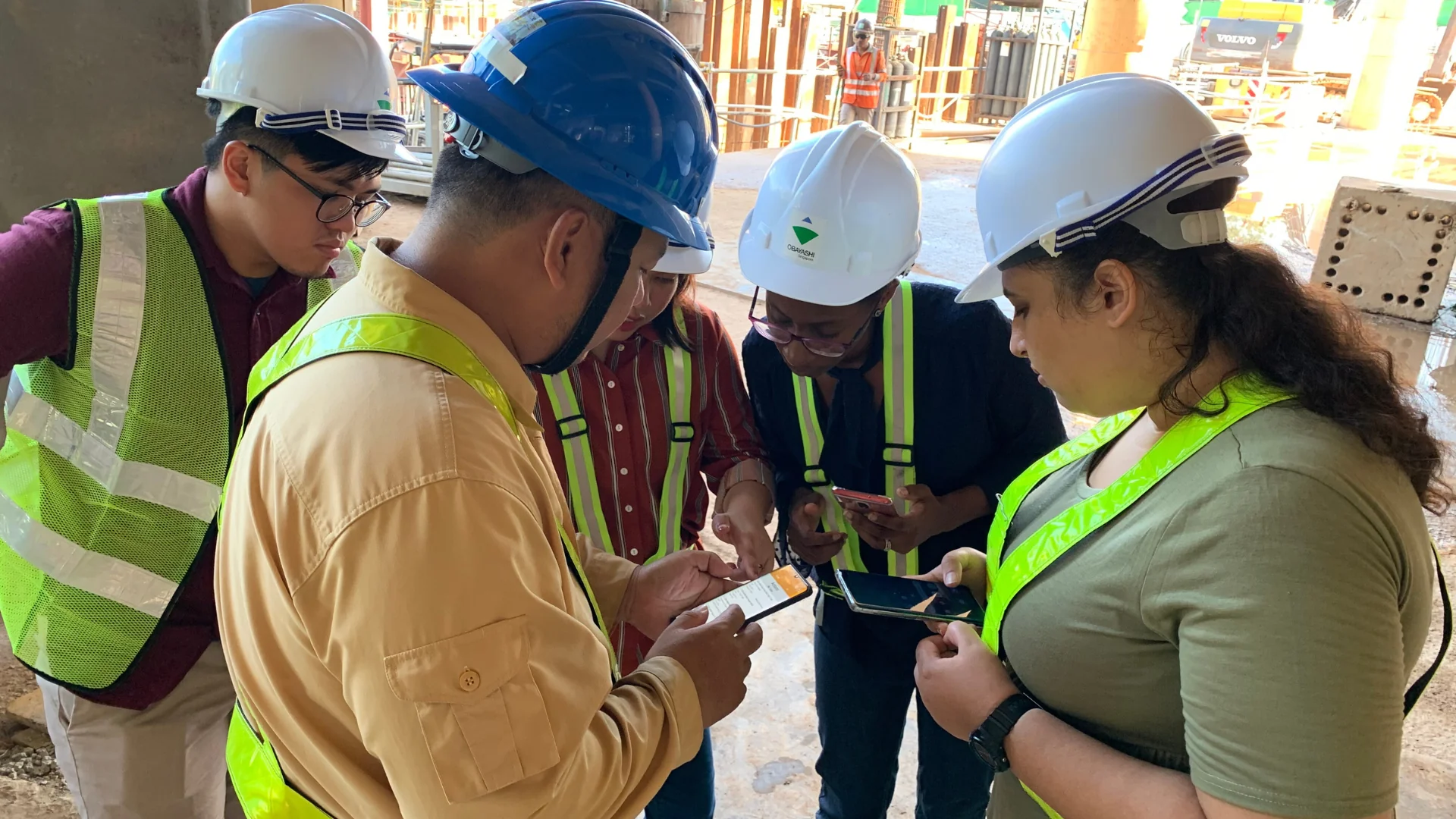 Construction team conducting toolbox meeting on job site