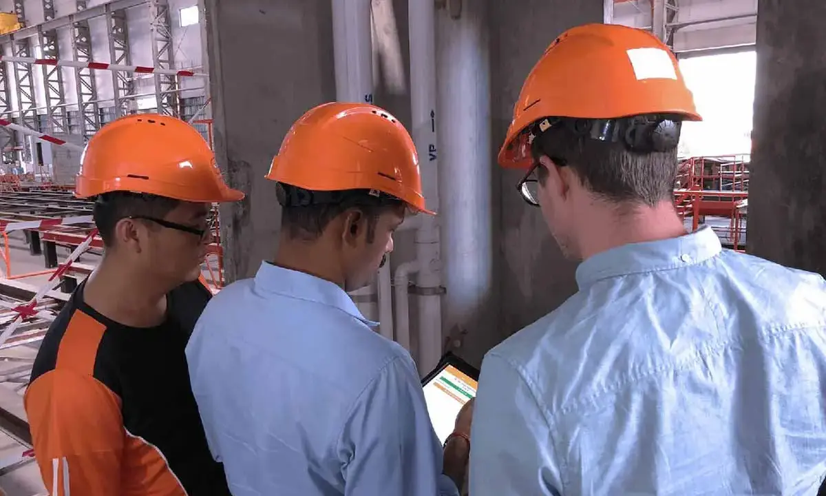Site managers inspecting construction project with digital quality control solution