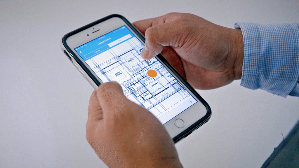 Construction worker using Novade mobile app for site inspection checklist