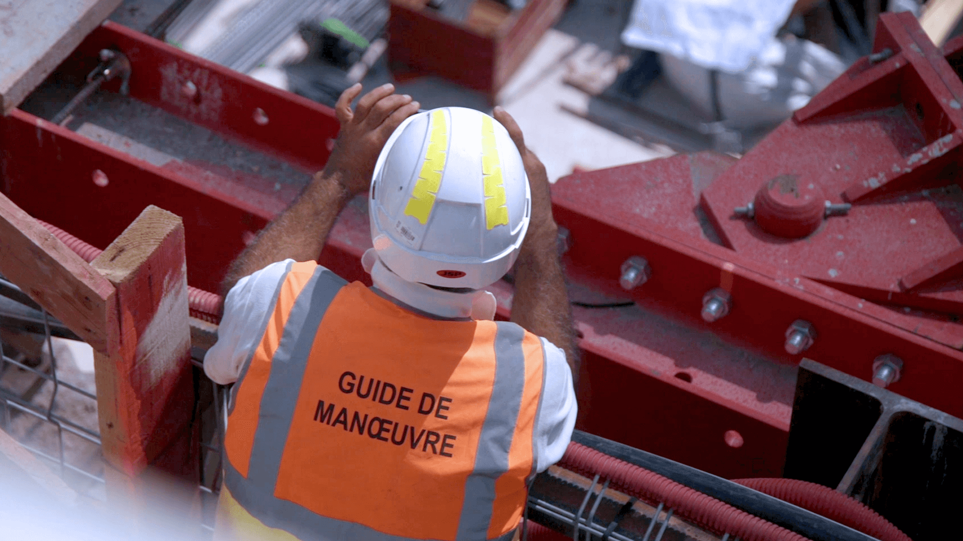 Site engineer in hard hat and safety vest on construction site
