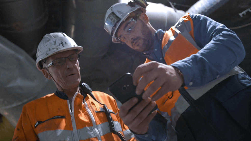Construction workers in protective gear collaborating on job site