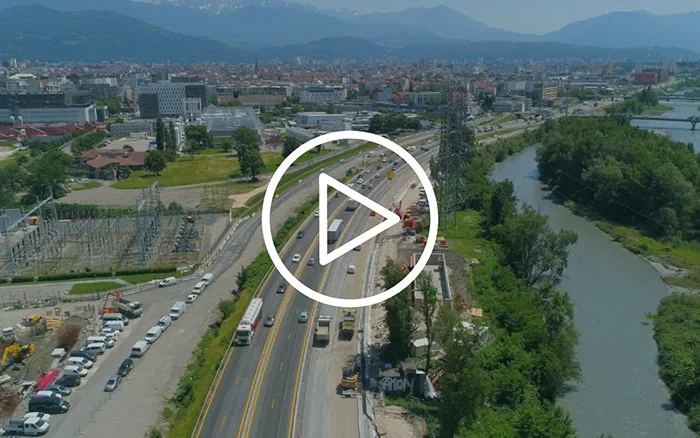 Aerial construction site on multi-lane highway with urban infrastructure management