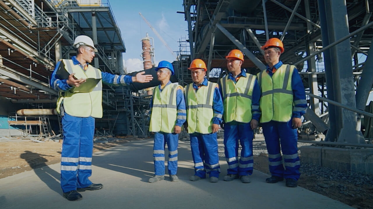 Construction workforce receiving briefing on active industrial site